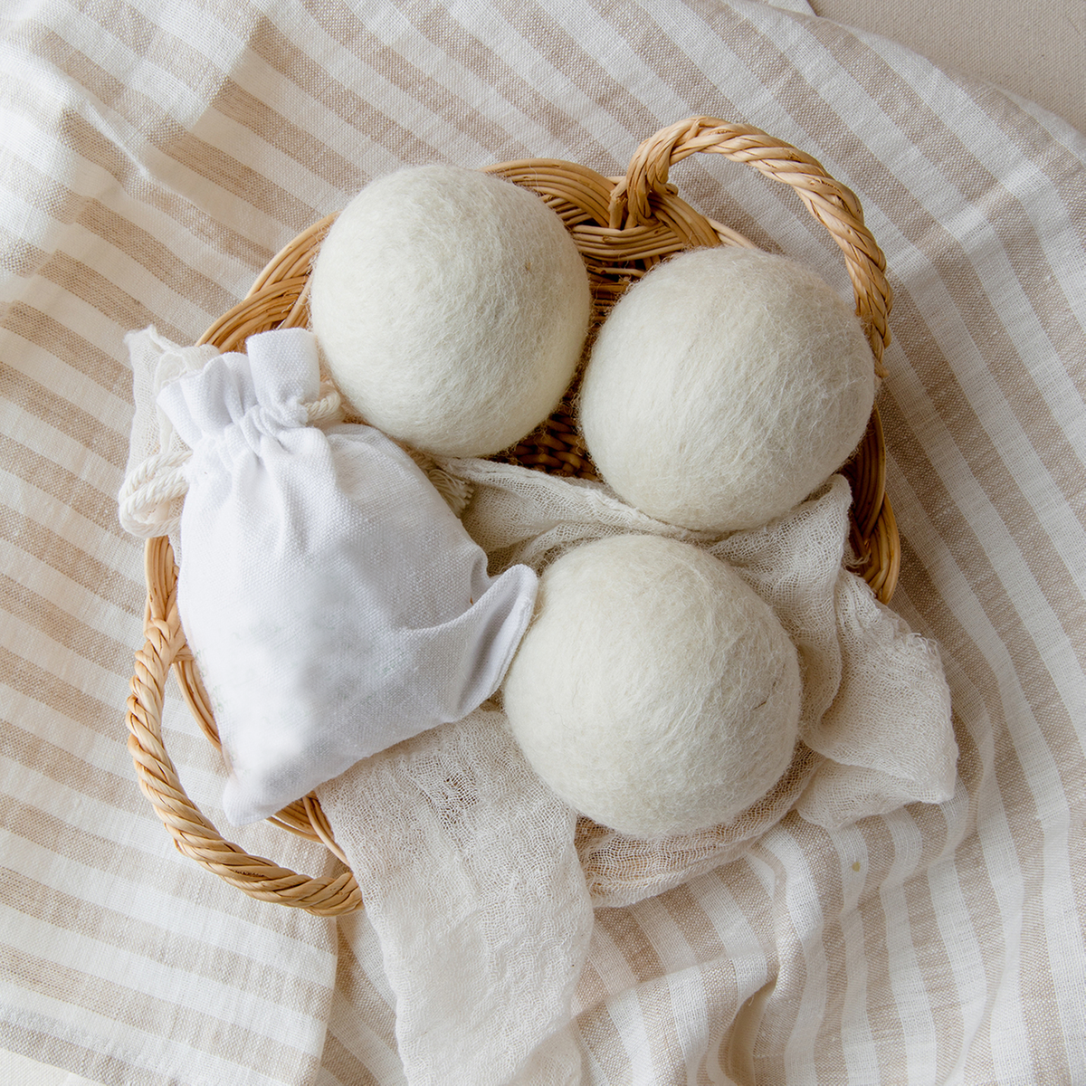 Three wool dryer balls in a small basket