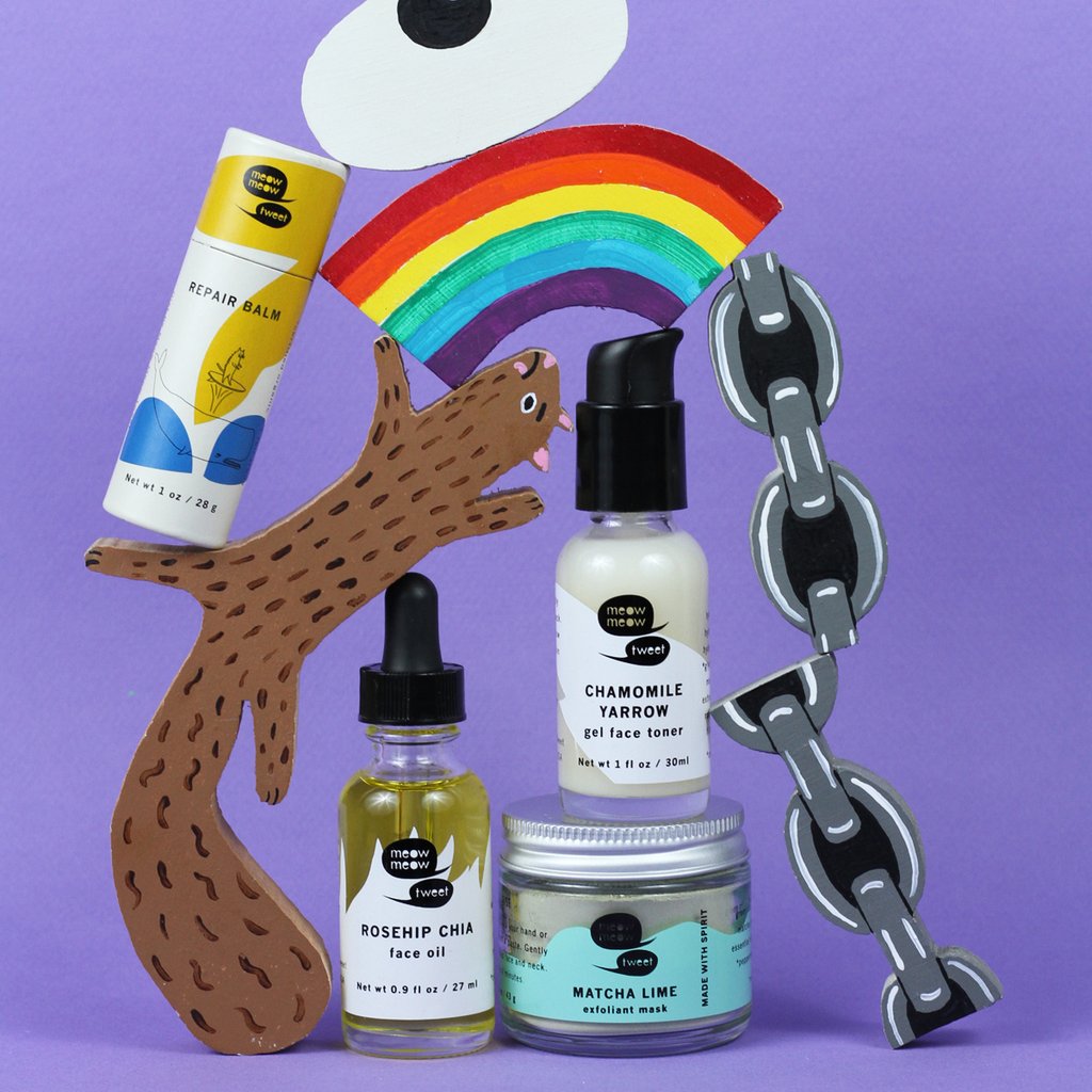 A selection of sustainable skin care products playfully arranged with painted cutouts of a squirrel, rainbow, and chains, all on a purple background