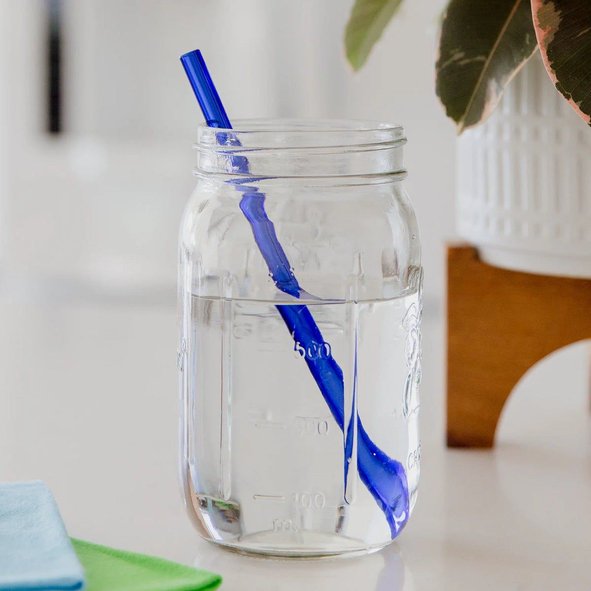 blue glass straw in a mason jar filled with water