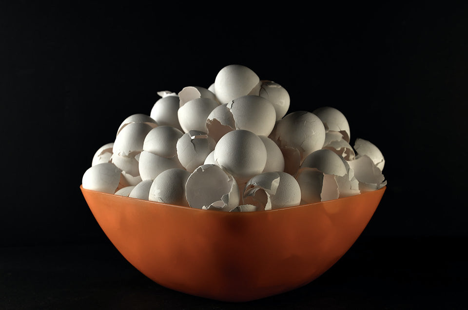 Bowl stacked high with eggshells in halves