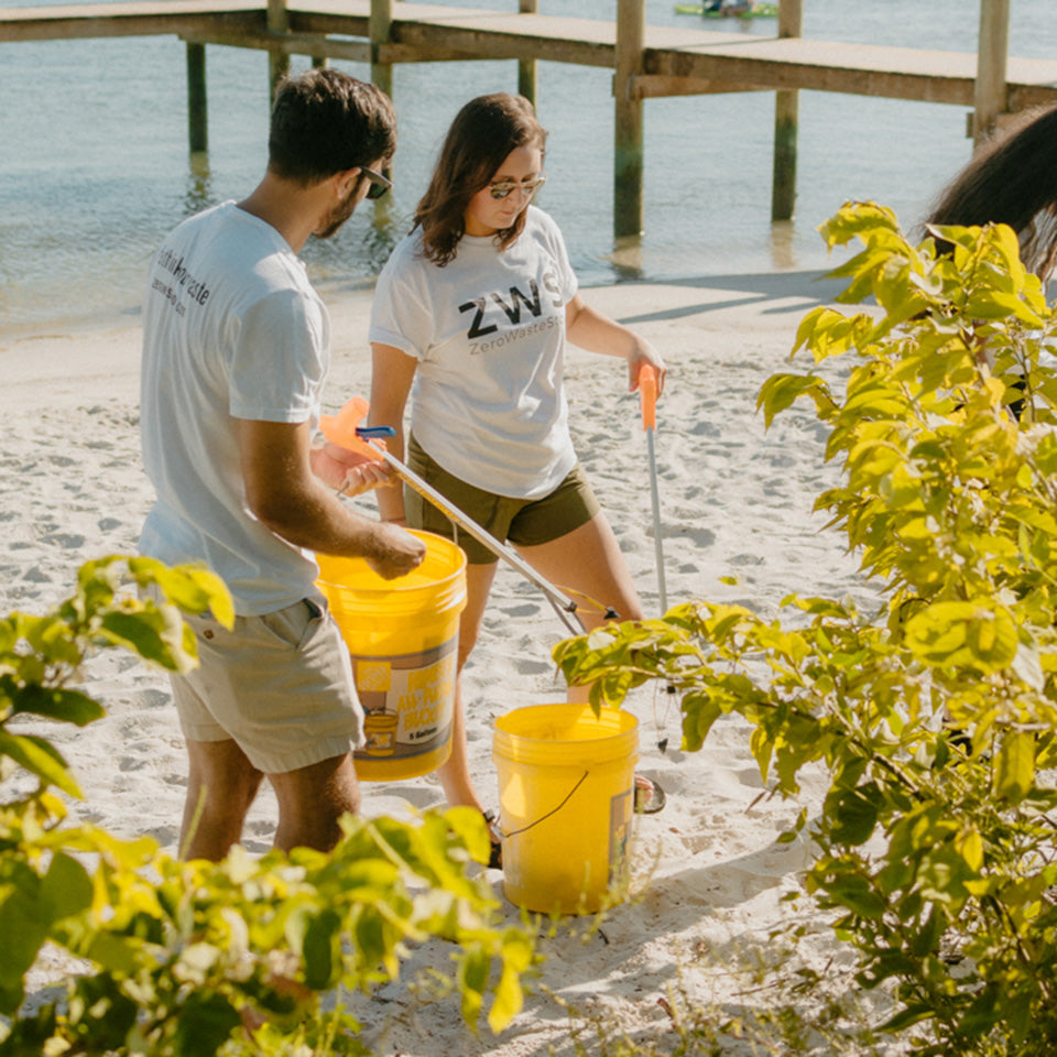 ZeroWasteStore team members picking up trash at the beach