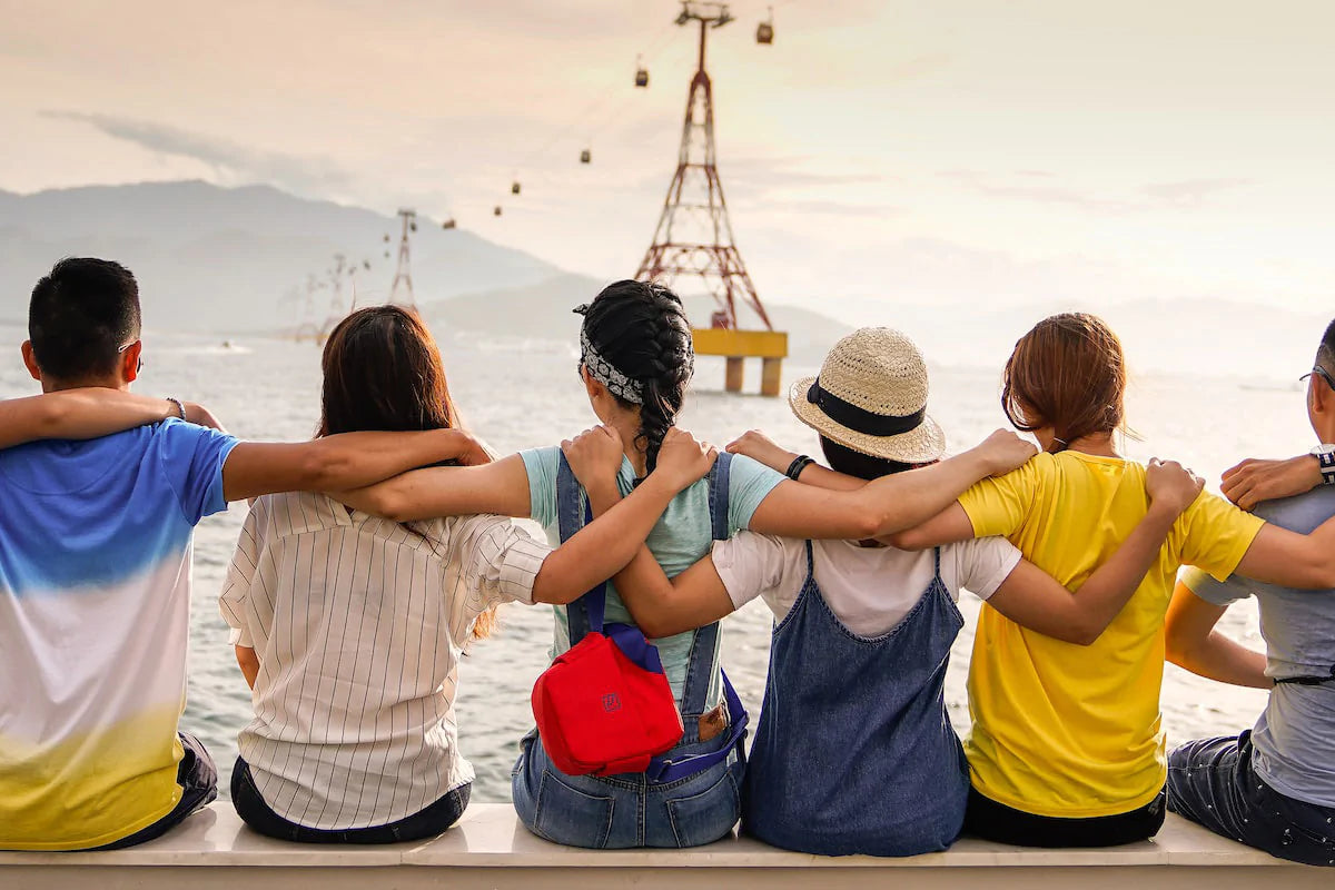 friends sitting looking out at the ocean