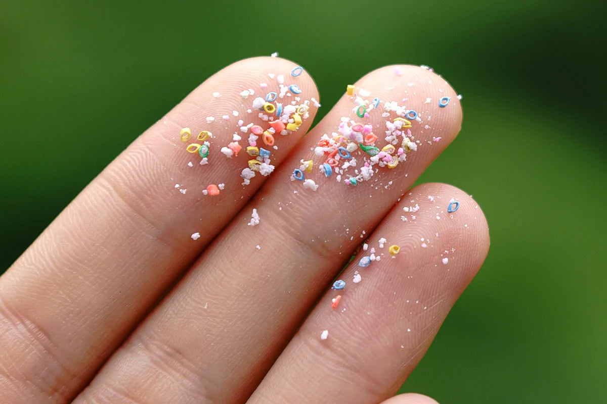 close up of microplastics on someone's fingers