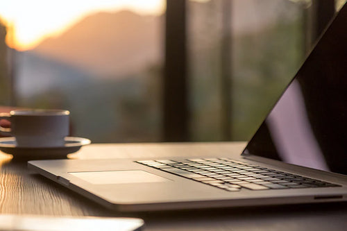 Open laptop and coffee cup