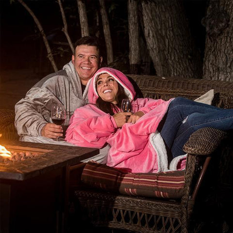man and woman wearing giant hoodie blankets