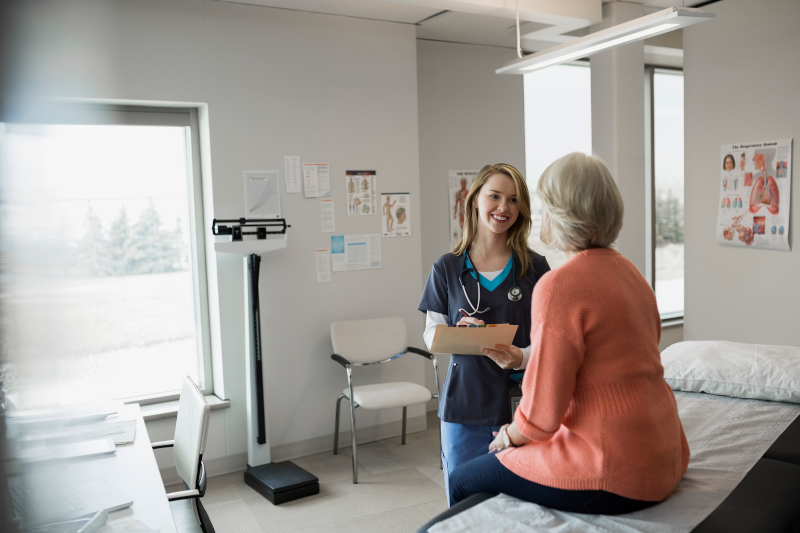 Client receiving ostomy consultation in health care setting