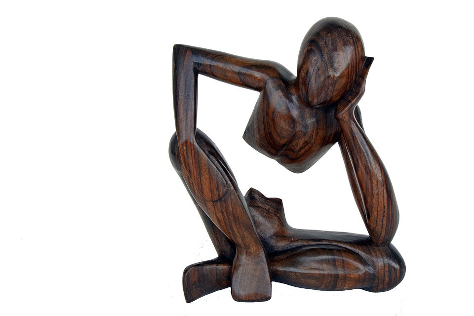 wooden carving of thinking figure