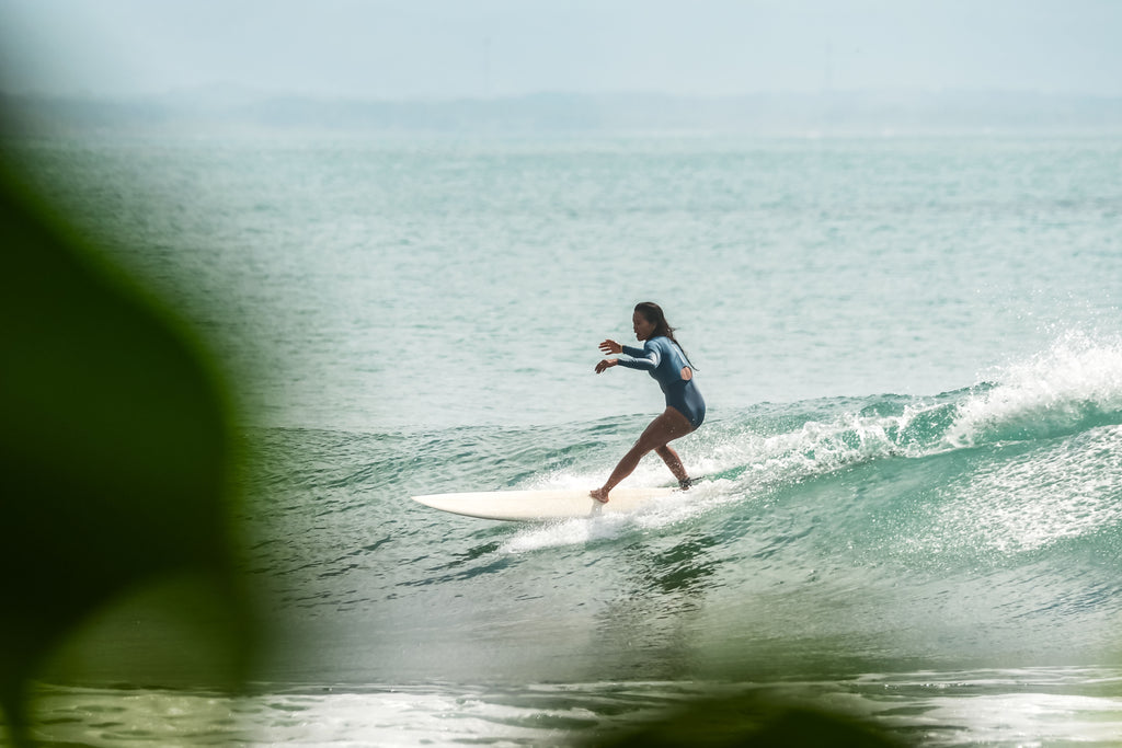 SEPTEMBER Surfer wearing Baja Surf Suit doing a cutback