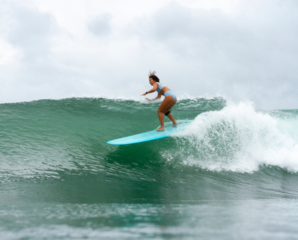 Erika falling on a surfboard