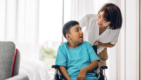 support worker or carer helping a child with a disability