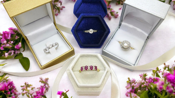 Antique & vintage rings in boxes surrounded by flowers
