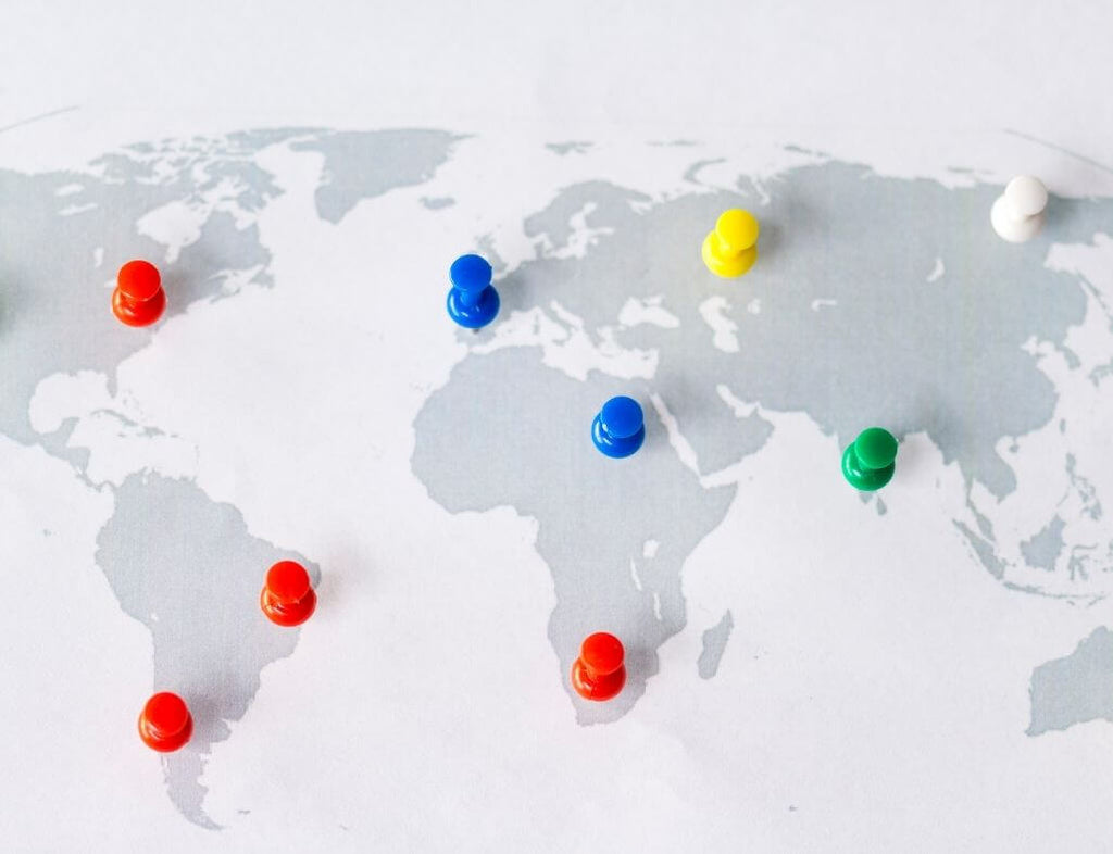 Different color pins on different regions on a world map 