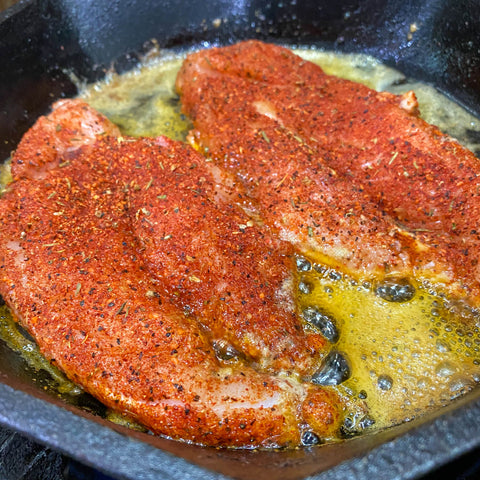 Blackened chicken cooking in butter 