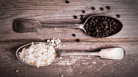 salt and pepper on spoon