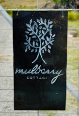 Mulberry Cottage Farm Stay Bumbaldry, Cowra, Grenfell metal sign with chalk paint writing of a mulberry tree and logo.