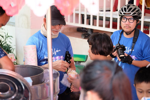 Khun Suchao scooping ice cream for the kids