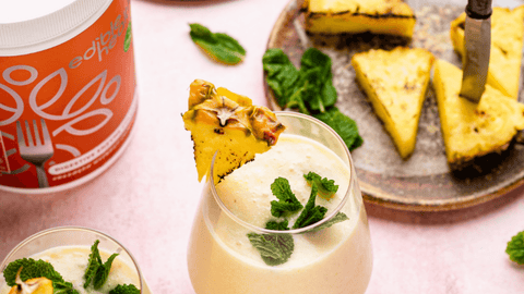 Pineapple cocktail with Digestive Enzyme Collagen powder in the background. 