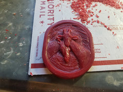 It starts with a carved wax design that will be turned into a mold