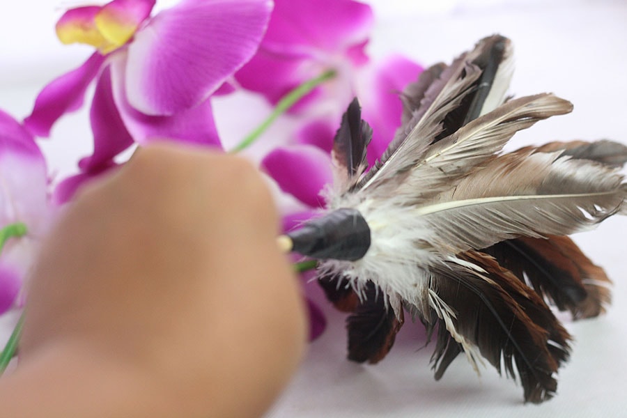 cleaning silk flowers with dust brush