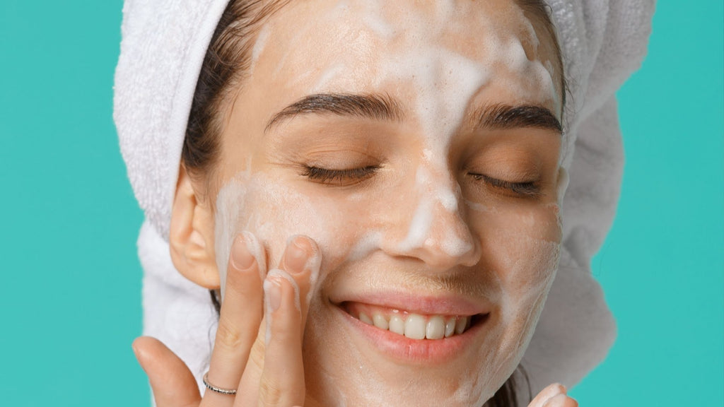 Woman applying Tailor Skincare Gel Cleanse foaming cleanser