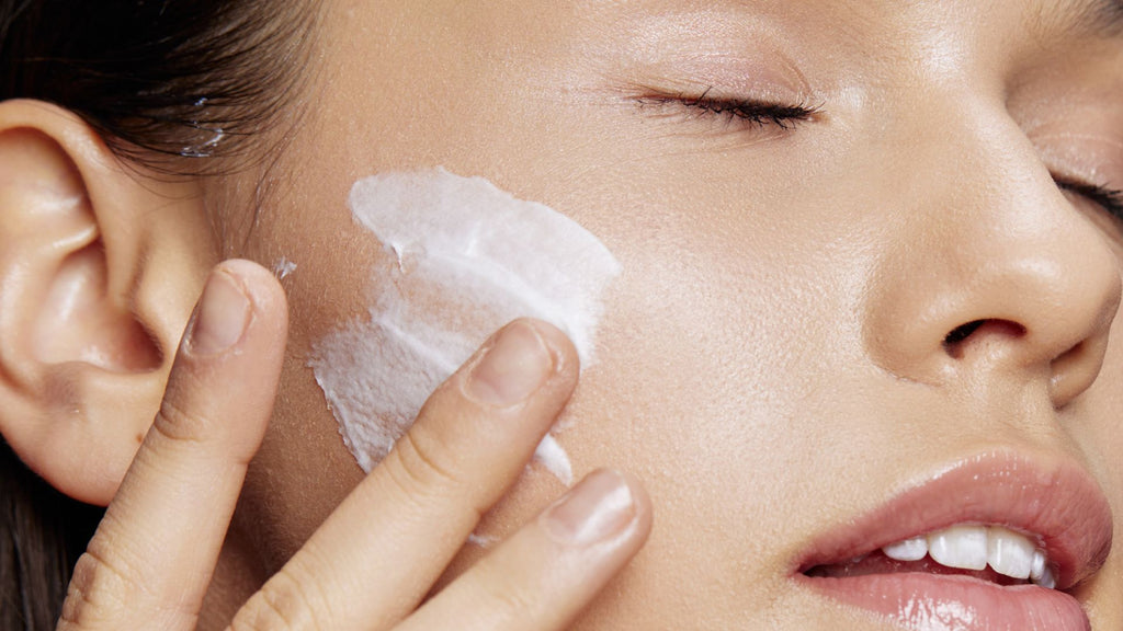 Woman applying Tailor Skincare Restore melatonin nurturing night balm