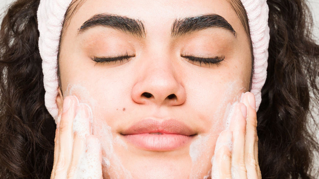 Woman applying Tailor Skincare Gel Cleanse to her face