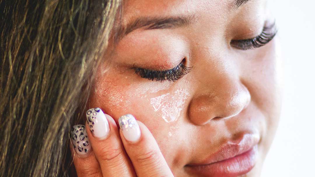 Woman Applying Silicone Free Gel To Her Face