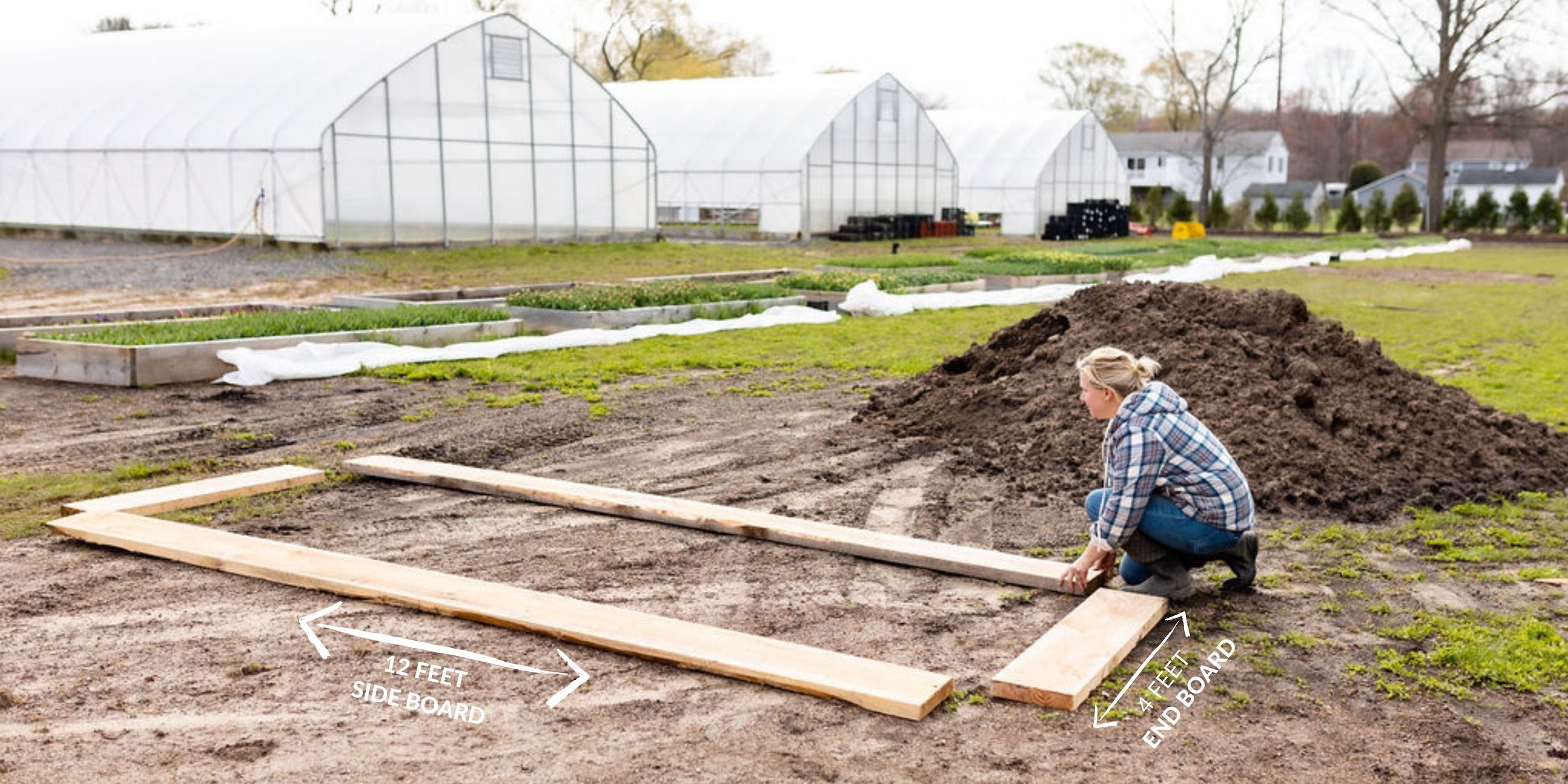 Laying out the lumber needed for a raised garden bed.