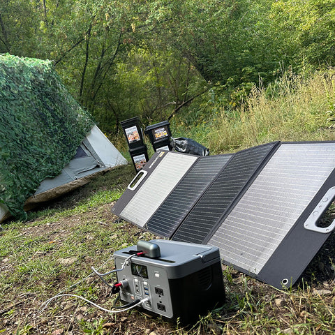 solar generator in the woods next to a tent