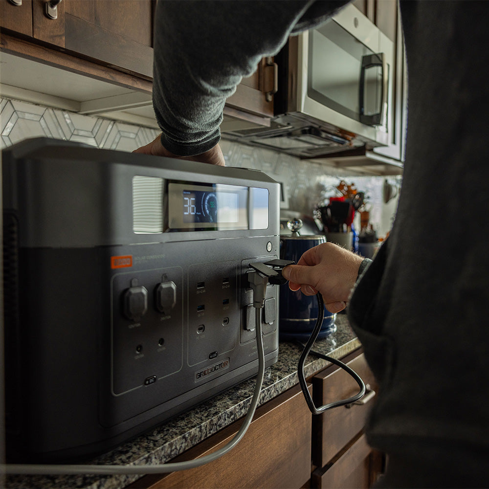 Shows the Grid Doctor battery being used to charge kitchen appliances.