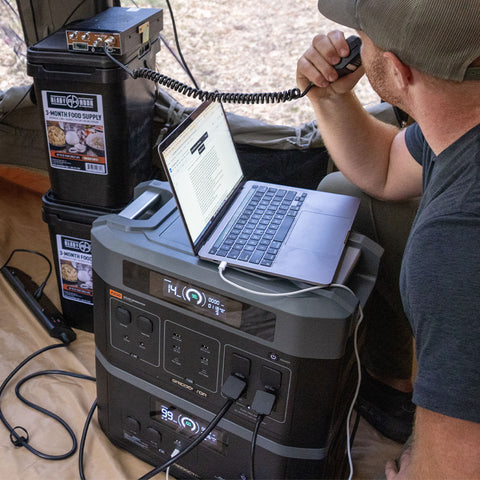 man next to solar generator speaking on a two way radio