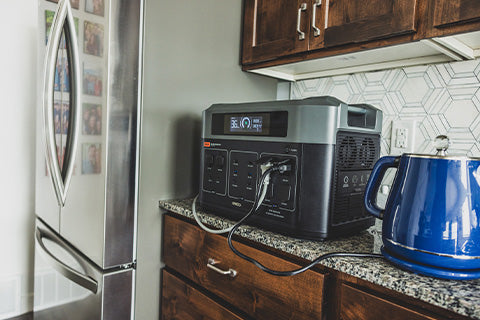 A generator placed on a kitchen counter inside a house.