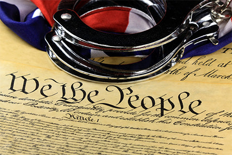 A set of handcuffs placed over the Declaration of Independence.