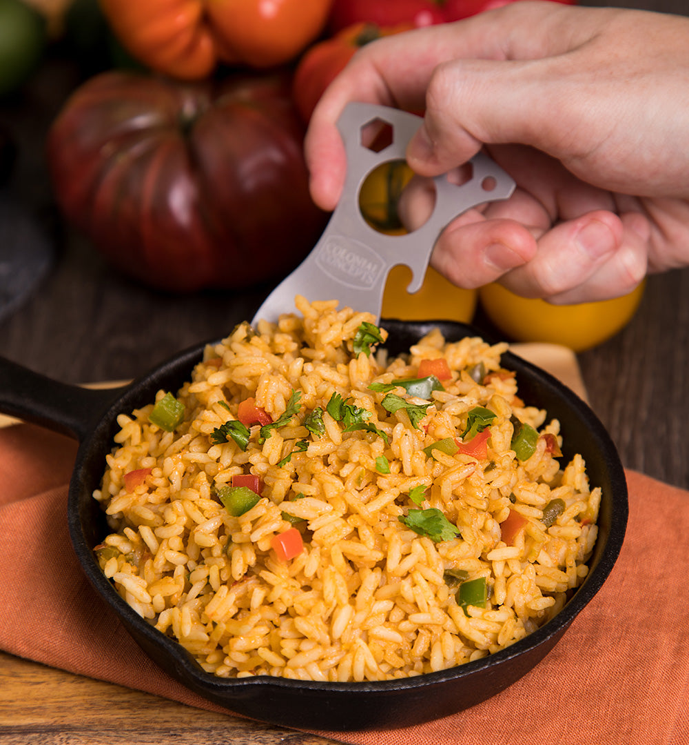 Someone scooping up our colorful Southwest Savory Rice with a camping utensil.