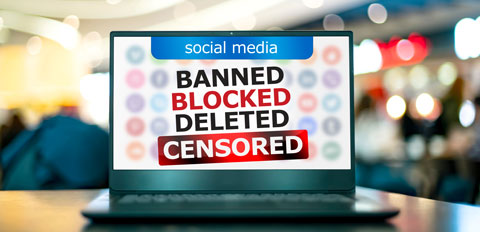 a laptop with the words banned, blocked, delete, censored on it