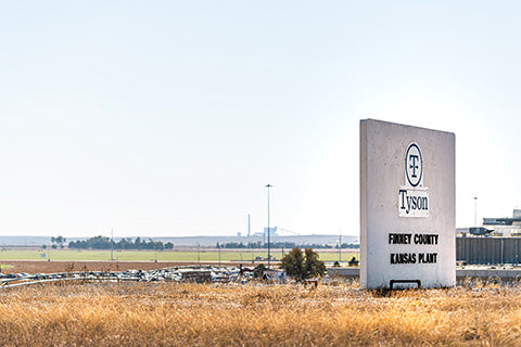 A sign indicating the location of a Tyson farm and meat-processing plant.