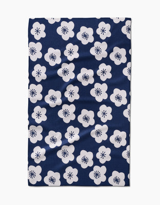 The Every Sunday tea towel by GEOMETRY features a navy blue design with evenly spaced white five-petaled flowers with starburst centers, crafted from soft Geoweave™ fabric.