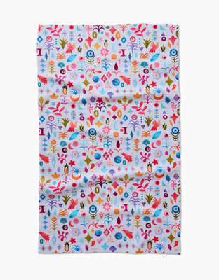 The Tula Tea Towel by Maayan Alper-Swan showcases a vibrant abstract floral and geometric pattern in red, blue, yellow, orange, and pink on white Geoweave fabric that is soft and eco-friendly.