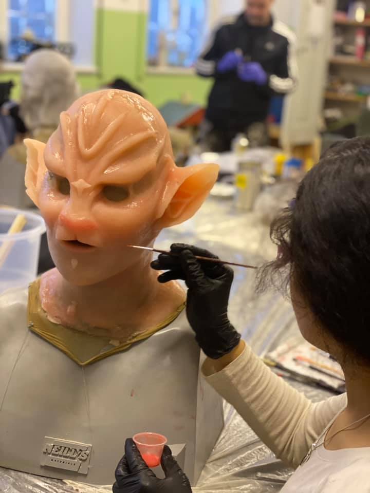 Student painting silicone mask in FX makeup class at Helsinglight FX Academy