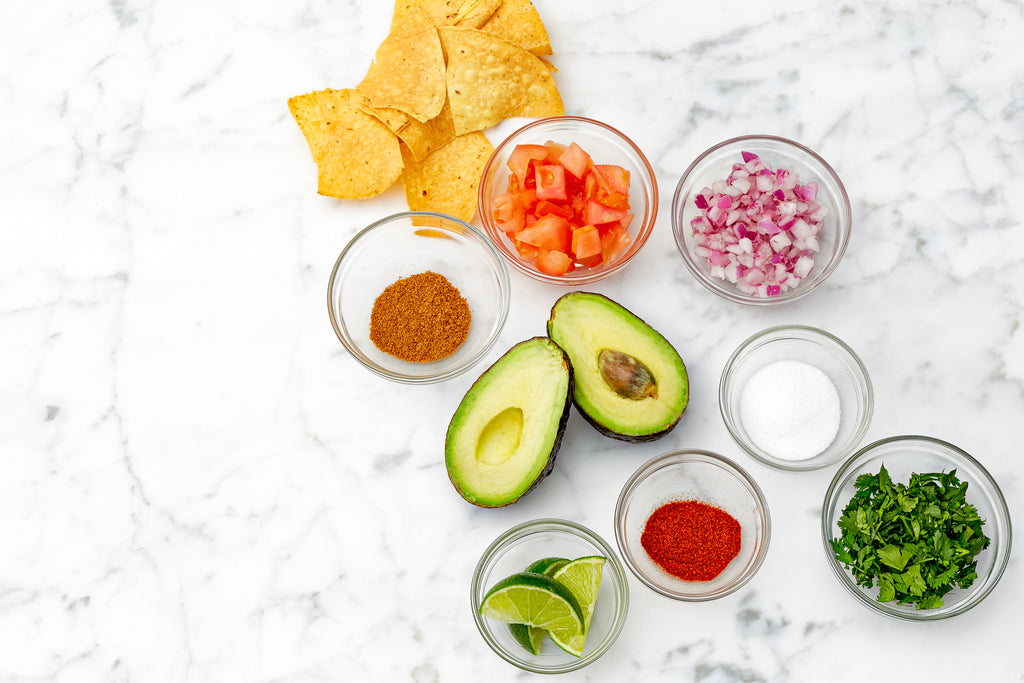 Guacamole ingredients on a marble table