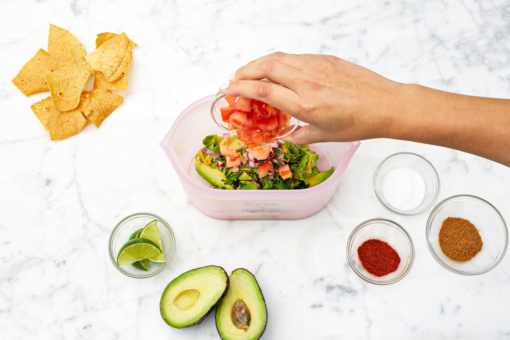 Reusable silicone container with guacamole recipe and ingredients