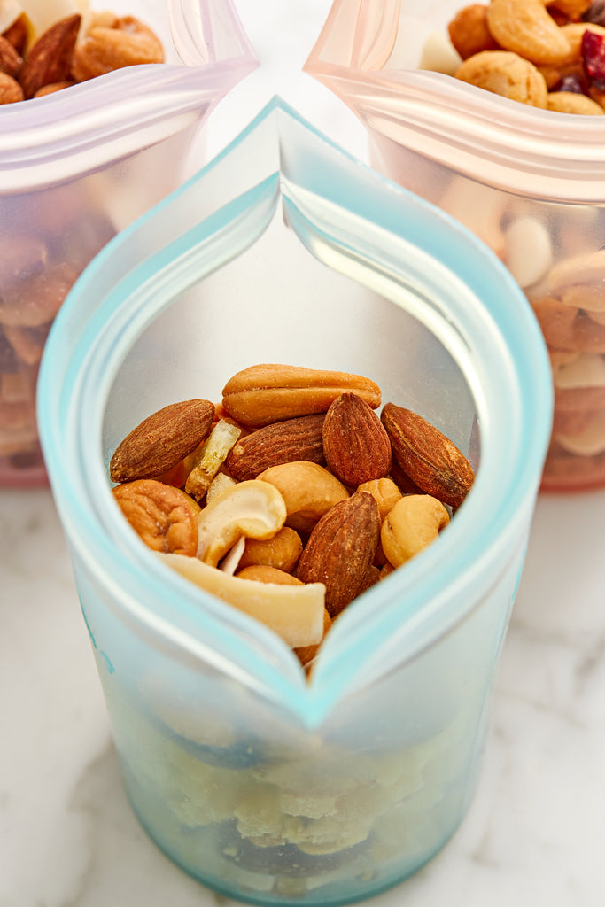 Small reusable teal cup with trail mix