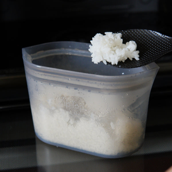 a Zip Top dish holding cooked rice in a microwave