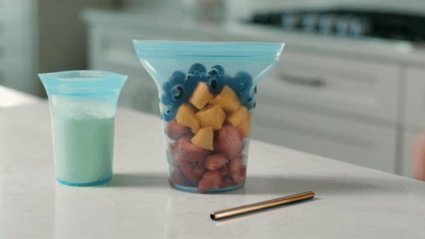 Blending smoothie with immersion blender in reusable silicone container