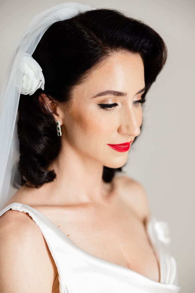 dainty satin hair flower in bride's glamorous downdo hair