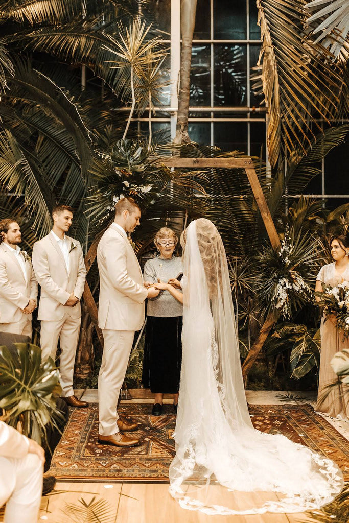 botanical palm tree wedding venue with modern bride in lace cathedral bridal veil