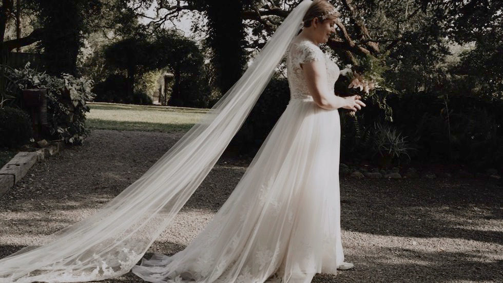 long cathedral lace veil attached in short pixie hairstyle on bride