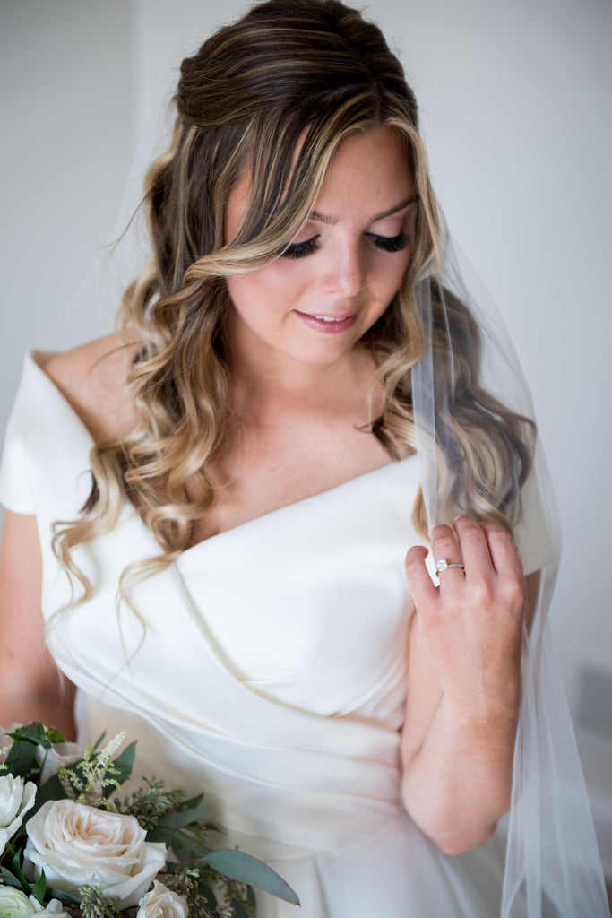 understated long wedding veil in bride's curled hair down for simple styles
