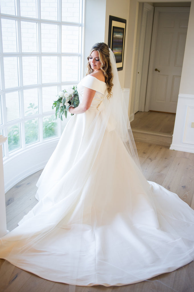 simple long cathedral veil with raw edge on bride in off shoulder ballgown dress