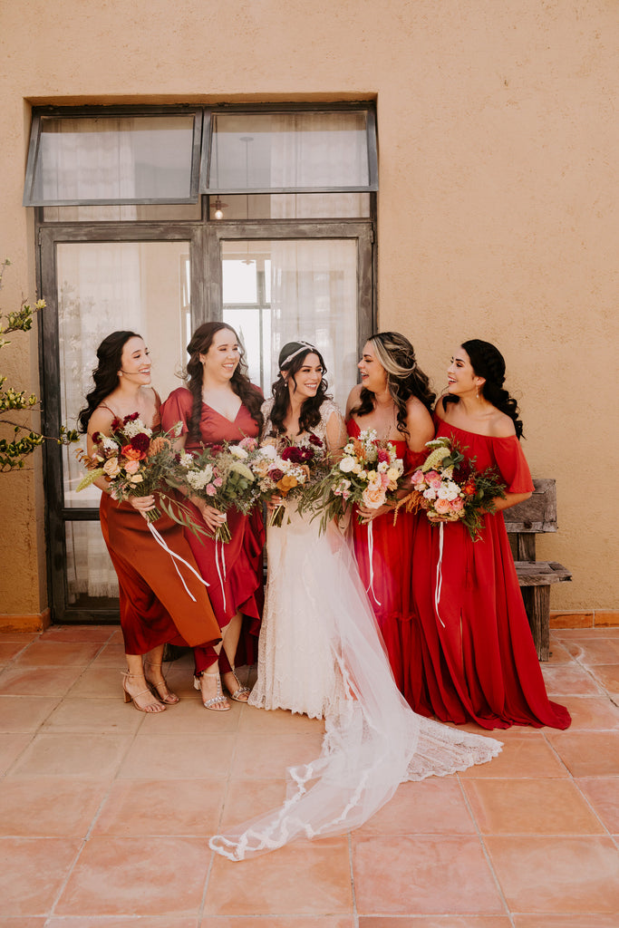 bright red Mexican wedding with bridesmaids in bold red dresses and bride in cathedral veil